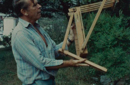Still from the film of Jerome Hill struggling with an easel.