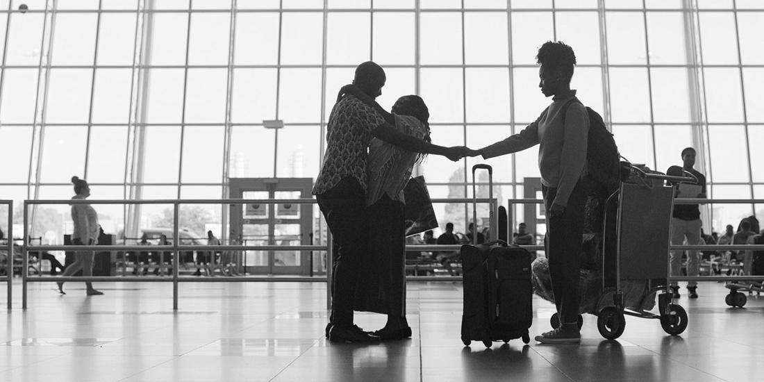 Family greeting each other at the JFK airport.