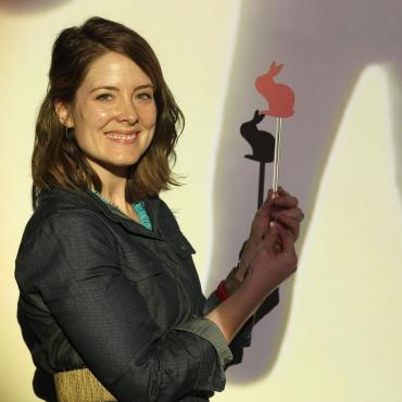 Megan Flød Johnson holding shadow puppet from "ShadowDreamScape", a commission from Children's Discovery Museum in San Jose, CA (2015).