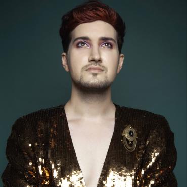 The artist wearing a gold sequin jacket