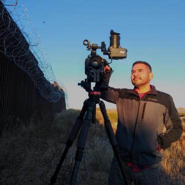 Rafael Samanez films the sun rising over the U.S. / Mexico Border Wall in Sasabe, Arizona.