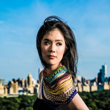 Photo of Stephanie Chou standing with Central Park and Manhattan skyline