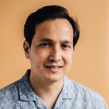 Nadav Kurtz, an Asian/Jewish male filmmaker, smiling at camera.