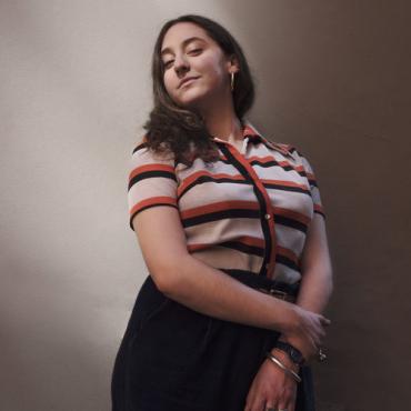 portrait of Sarah Friedland, smiling and looking down to the camera