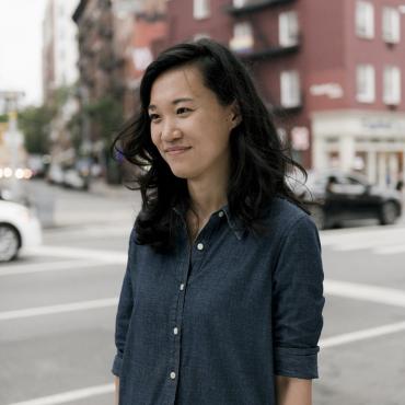 Jenny Xie, a thirty-something Chinese American writer, standing at an intersection in New York City’s Greenwich Village.