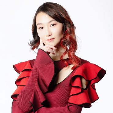 Jiabao Li, a Chinese woman artist in her coral-like red dress.