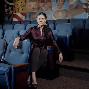 Sarah Bellamy, seated at the Penumbra Theatre and looking into the camera.