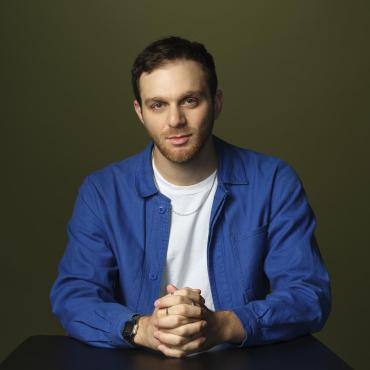 Matt Nadel, a twenty-something white man, looking at the camera with a closed mouth.